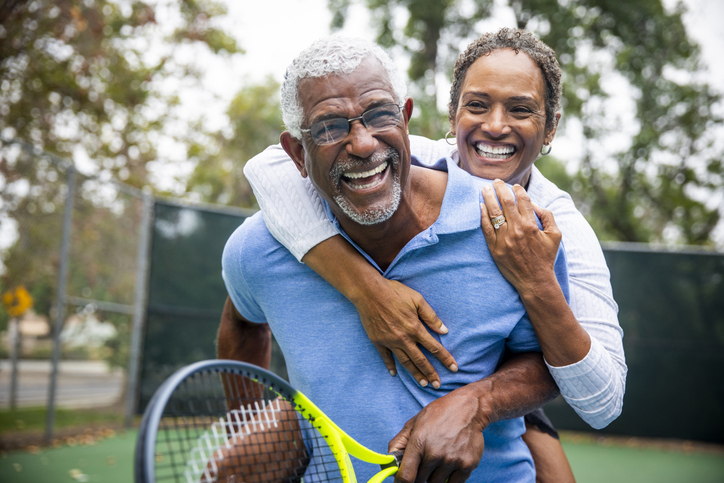 Senior Black Couple on Tennis Court Piggyback